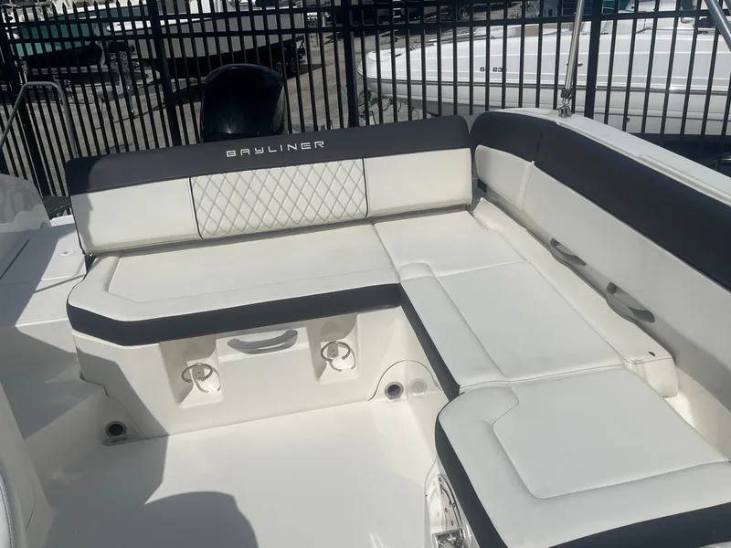 Slide: The Image of 2022 Bayliner DX 2200 boat interior with white seating and black accents. - 7
