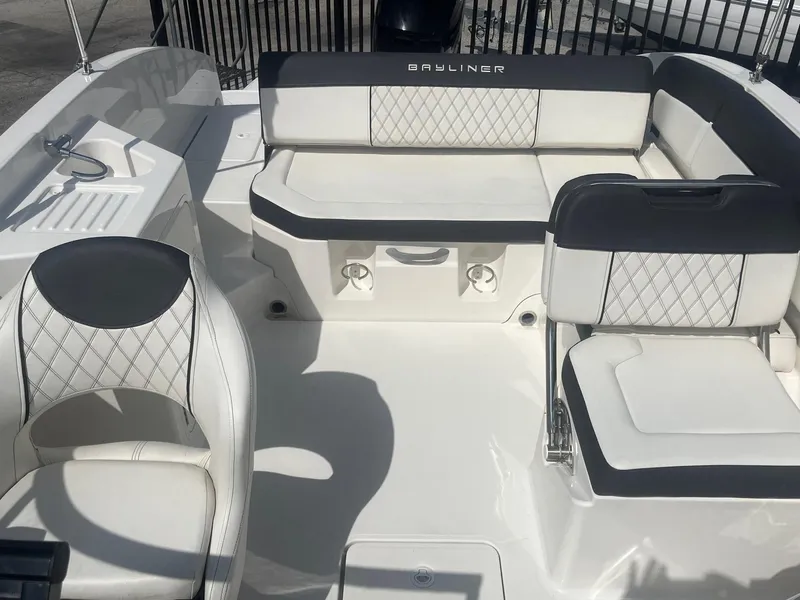 Slide: The Image of 2022 Bayliner DX 2200 boat interior with white and black seating, showcasing modern design. - 9