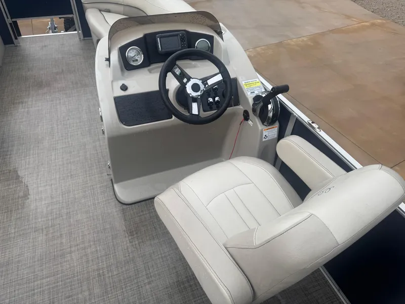 Slide: The Image of 2022 Cypress Cay Seabreeze 232 boat interior with steering console and captain's chair. - 4