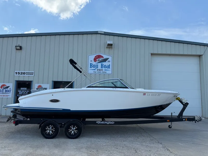 Slide: The Image of 2019 Cobalt CS23 boat on trailer outside Boji Boat Brokers building. - 0