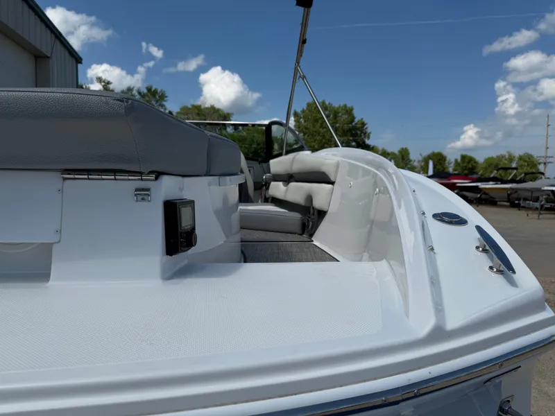 Slide: The Image of 2019 Cobalt CS23 boat with sleek white design and comfortable seating, under a clear blue sky. - 10