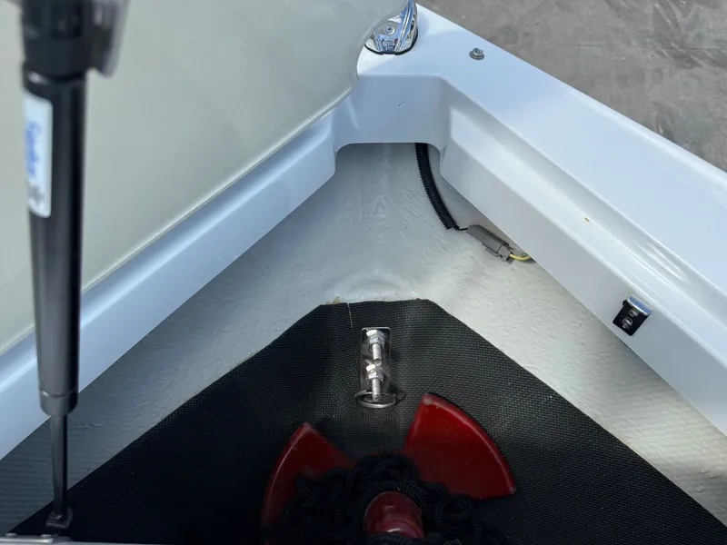 Slide: The Image of 2019 Cobalt CS23 boat anchor storage compartment with red anchor and black rope. - 13