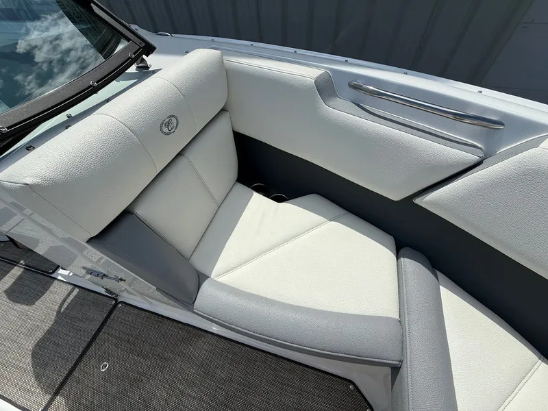 Slide: The Image of 2019 Cobalt CS23 boat interior with white leather seating and sleek design. - 15