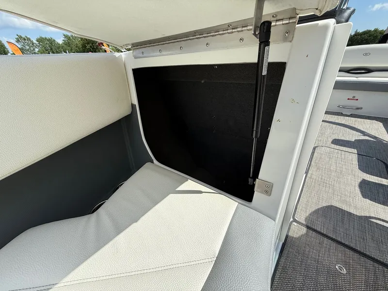 Slide: The Image of 2019 Cobalt CS23 boat interior storage compartment with cushioned seating and hydraulic lift. - 19