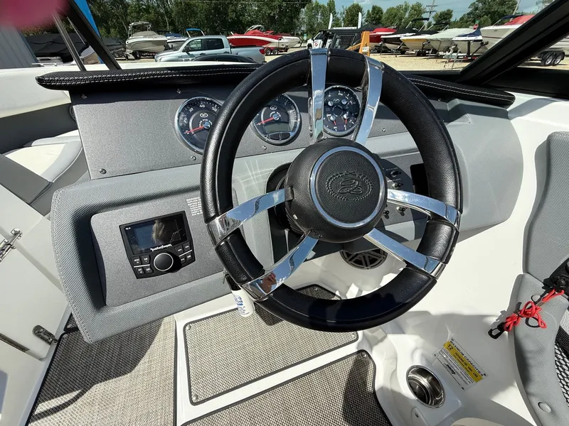 Slide: The Image of 2019 Cobalt CS23 boat dashboard with steering wheel and control panel. - 21
