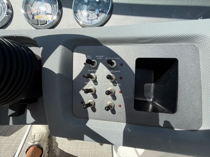 Slide: The Image of Control panel of a 2019 Cobalt CS23 boat with switches and gauges. - 24