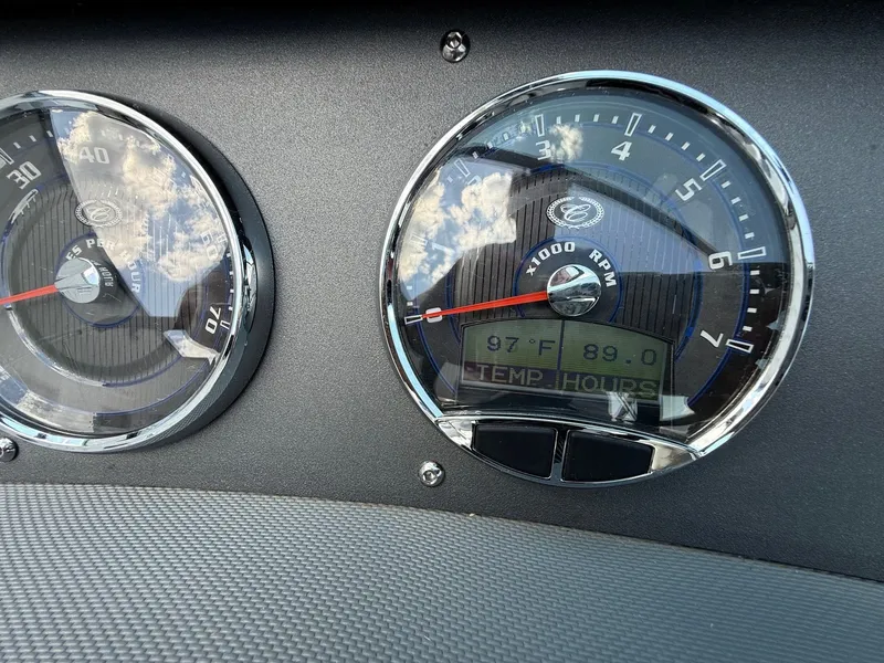 Slide: The Image of Dashboard of a 2019 Cobalt CS23 boat showing temperature and RPM gauges. - 25