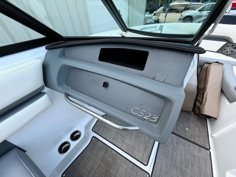 Slide: The Image of Interior of a 2019 Cobalt CS23 boat, featuring a glove compartment and seating area. - 27