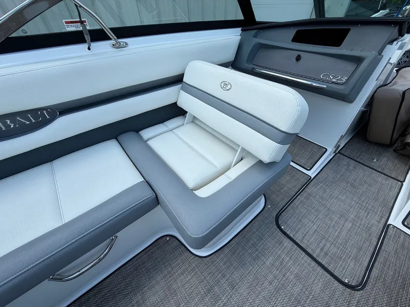 Slide: The Image of 2019 Cobalt CS23 boat interior with white and gray seating, sleek design. - 29
