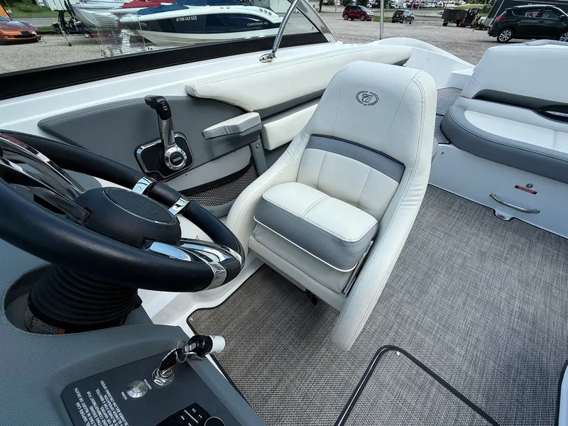 Slide: The Image of 2019 Cobalt CS23 boat interior with steering wheel and cushioned seating. - 30
