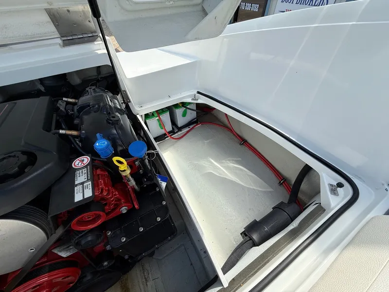 Slide: The Image of Engine compartment of a 2019 Cobalt CS23 boat, showing engine and battery storage. - 35