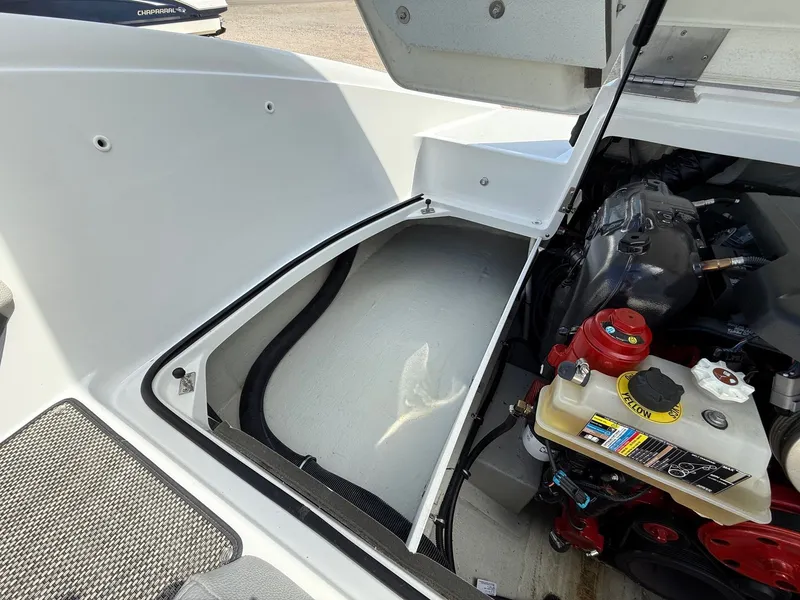 Slide: The Image of Open engine compartment of 2019 Cobalt CS23 boat, showing engine and storage area. - 36