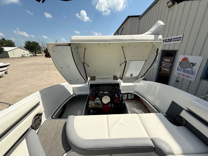 Slide: The Image of 2019 Cobalt CS23 boat engine compartment open, showcasing interior mechanics and seating area. - 37