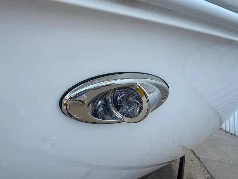 Slide: The Image of 2019 Cobalt CS23 boat with chrome light detail on white hull. - 4