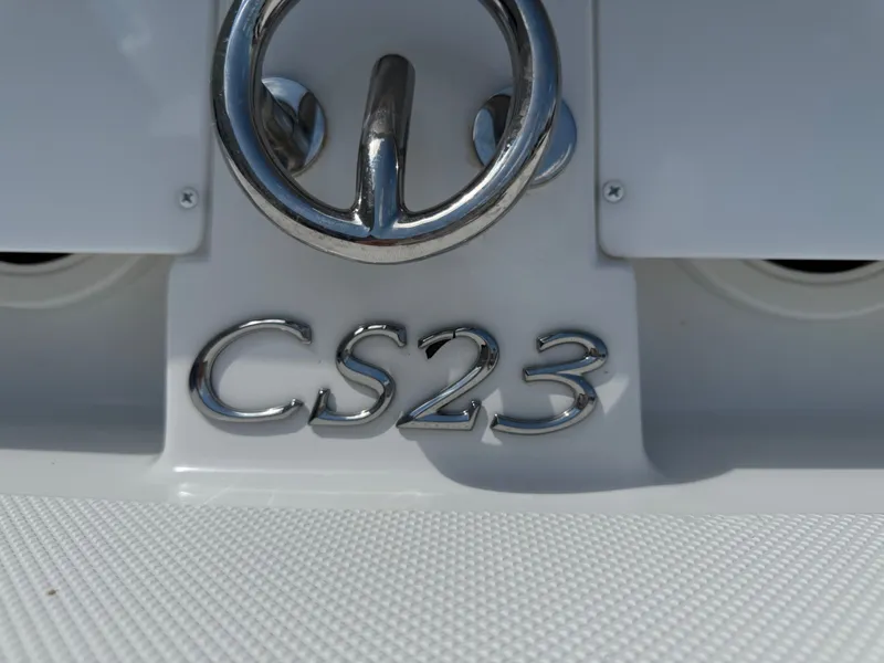 Slide: The Image of 2019 Cobalt CS23 boat emblem with chrome detailing on a white surface. - 6