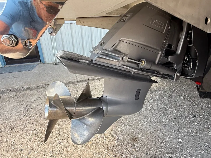 Slide: The Image of Close-up of a 2019 Cobalt CS23 boat propeller and outdrive on gravel surface. - 7