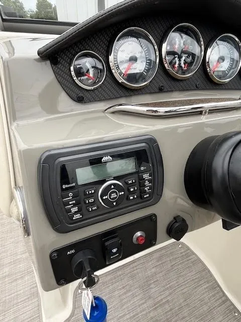 Slide: The Image of Dashboard of a 2018 Stingray 235 LR boat with gauges and audio system. - 11
