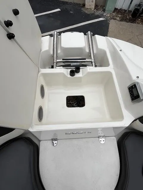 Slide: The Image of 2018 Stingray 235 LR boat storage compartment with ladder and seating area. - 18
