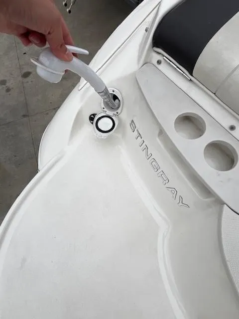 Slide: The Image of Filling fuel on a 2018 Stingray 235 LR boat at a dock. - 25