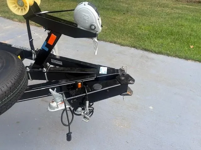 Slide: The Image of Trailer hitch and winch of a 2018 Stingray 235 LR boat on pavement. - 27