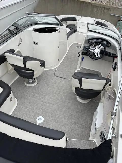 Slide: The Image of 2018 Stingray 235 LR boat interior with steering wheel, seating, and dashboard. - 6