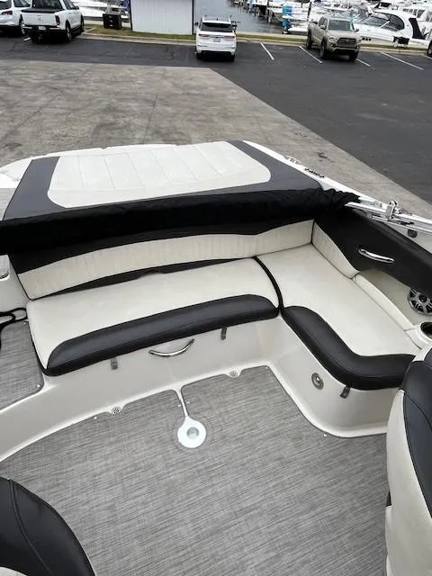 Slide: The Image of 2018 Stingray 235 LR boat interior with cushioned seating and modern design. - 7