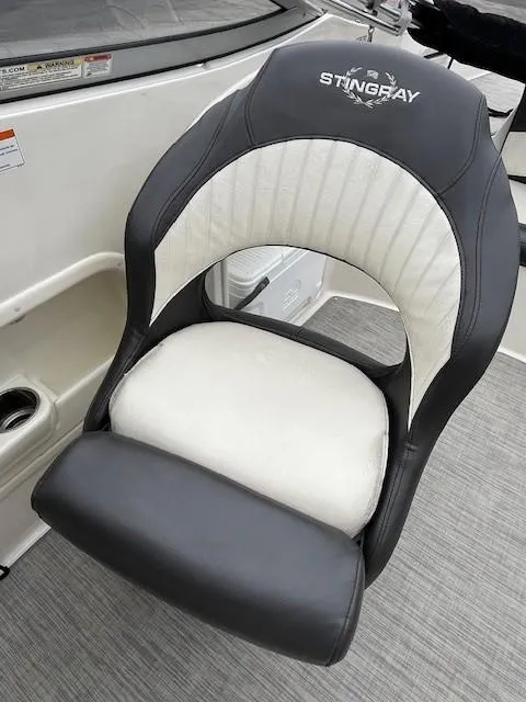 Slide: The Image of 2018 Stingray 235 LR boat seat with black and white upholstery. - 9