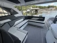 Slide: The Image of 2022 Cruisers 42 GLS yacht interior with sleek seating and waterfront view. - 15