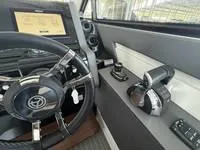 Slide: The Image of Interior view of 2022 Cruisers 42 GLS yacht cockpit with steering wheel and controls. - 22