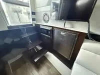 Slide: The Image of Interior of 2022 Cruisers 42 GLS yacht with modern kitchen and seating area. - 25