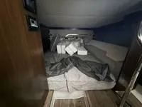 Slide: The Image of Interior cabin of 2022 Cruisers 42 GLS yacht with unmade bed and cushions. - 29