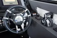 Slide: The Image of Steering wheel and controls of 2022 Cruisers 42 GLS yacht cockpit. - 42
