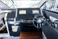 Slide: The Image of 2022 Cruisers 42 GLS yacht helm with dual displays and modern controls. - 43