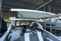 Slide: The Image of 2022 Cruisers 42 GLS luxury yacht with open deck under a covered marina. - 46