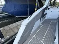 Slide: The Image of Luxurious 2022 Cruisers 42 GLS yacht interior with sleek seating and waterfront view. - 11