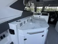 Slide: The Image of 2022 Cruisers 42 GLS yacht storage compartment with cleaning supplies on a sleek deck. - 13