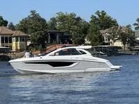 Slide: The Image of 2022 Cruisers 42 GLS yacht on a serene lake with waterfront homes in the background. - 2