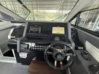 Slide: The Image of Luxurious interior of 2022 Cruisers 42 GLS yacht with white seating and wooden table. - 23