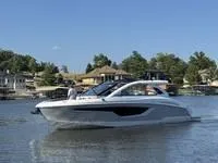Slide: The Image of 2022 Cruisers 42 GLS yacht on a serene lake with luxury homes in the background. - 3