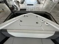 Slide: The Image of 2022 Cruisers 42 GLS yacht docked under a covered marina, featuring sleek design and spacious seating. - 33