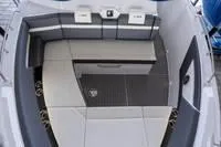 Slide: The Image of 2022 Cruisers 42 GLS yacht kitchenette with stainless steel appliance and white cabinetry. - 49