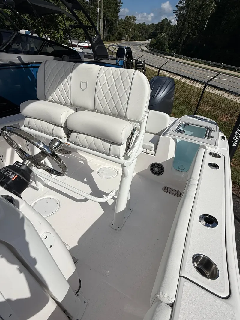 Slide: The Image of 2026 Sea Fox 228 Commander boat interior with white seating and steering wheel. - 11