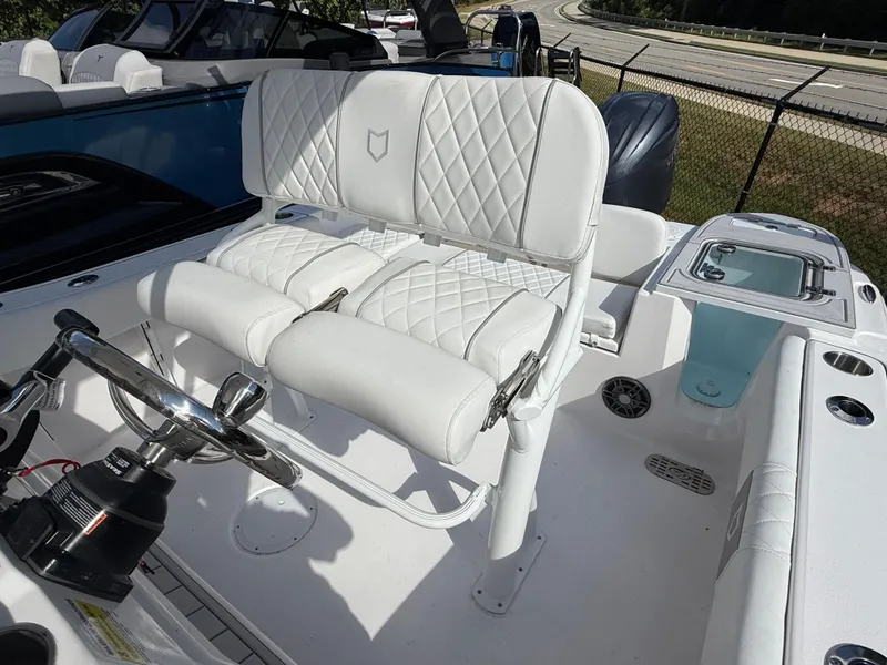 Slide: The Image of 2026 Sea Fox 228 Commander boat interior with white cushioned seating and steering wheel. - 12