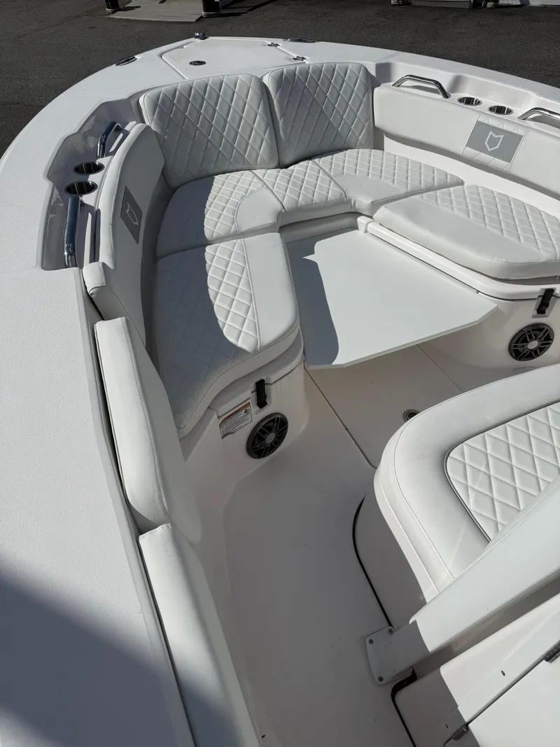 Slide: The Image of 2026 Sea Fox 228 Commander boat interior with white quilted seating and cup holders. - 7