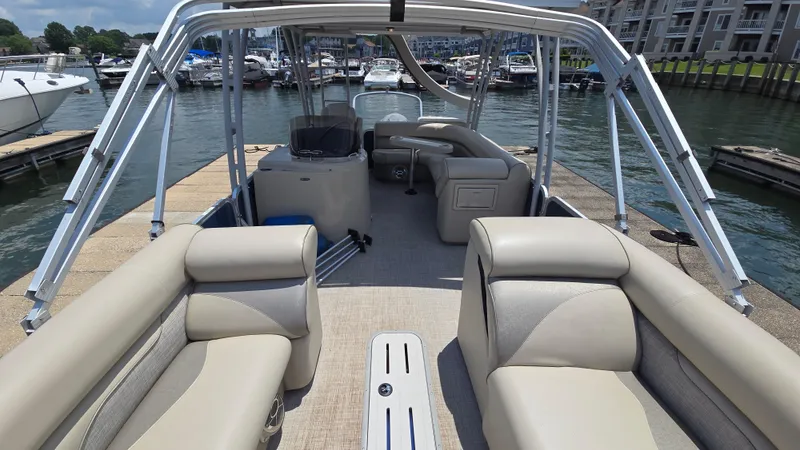 Slide: The Image of 2017 Premier 240 SunSation pontoon boat docked, featuring spacious seating and sleek design. - 10