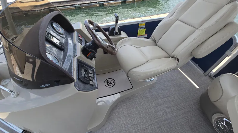 Slide: The Image of 2017 Premier 240 SunSation boat interior with steering console and plush captain's chair. - 13