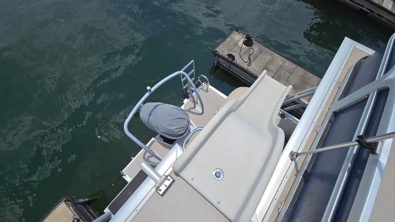 Slide: The Image of 2017 Premier 240 SunSation pontoon boat with slide, docked on calm water. - 19