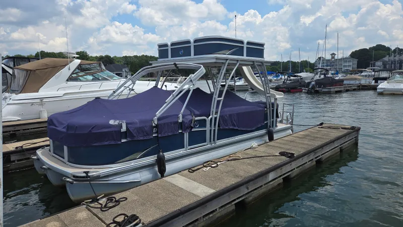 Slide: The Image of 2017 Premier 240 SunSation pontoon boat docked at marina under cloudy sky. - 2