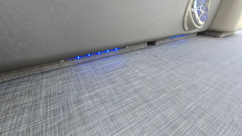 Slide: The Image of 2017 Premier 240 SunSation boat interior with blue LED lights and speaker. - 24