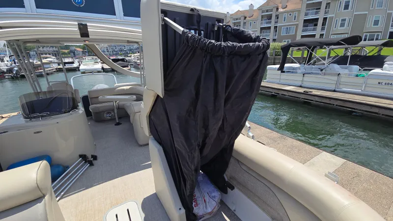 Slide: The Image of 2017 Premier 240 SunSation pontoon boat with privacy curtain, docked at marina. - 26